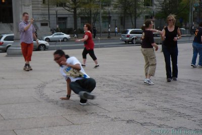 When the music gets funky, some bystanders start to break-dance