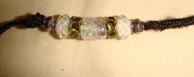 White iridescent glass center bead with green rondells and silver toned accents
