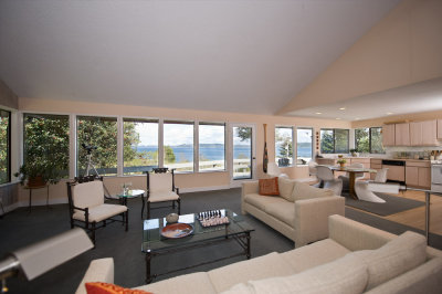 Living room, dining area, kitchen and  view of Puget Sound