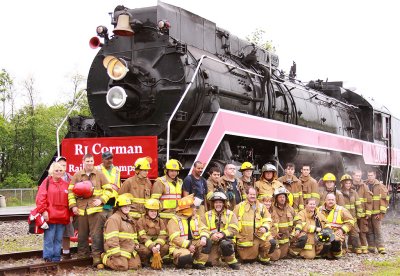 Members of the Bagdad fire Dept. pose for a group shot after helping to service the locomotive
