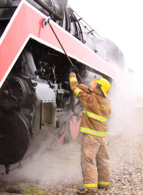 Members of the Bagdad fire Dept. wash the locomotives down during a service stop 