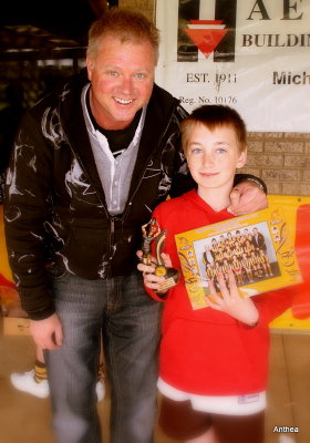 Daniel with his coach and his trophy