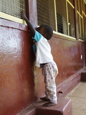 Boy climbing to window Sanyu Babies Home Kampala Uganda