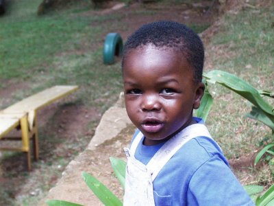 Little boy looking over shoulder Sanyu Babies Home Kampala Uganda