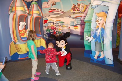 Showing Mickey his shoes.