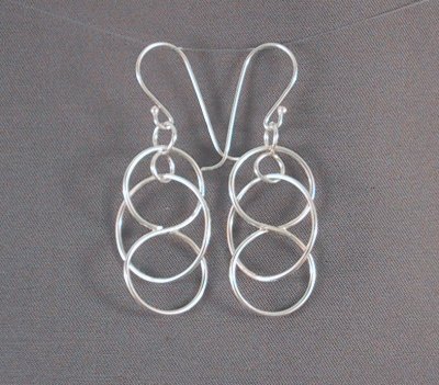 Sterling 3.5 cm long earrings with a hoop threaded within a figure-8 that moves constantly.
