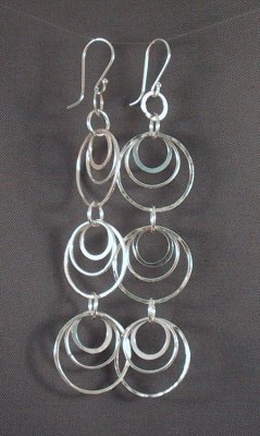 Sterling 8cm long earrings with 3 sets of 3 concentric circles each.  Some of the circles are hammered for a different texture.