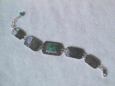hammered sterling set with a 10 x 14mm turquoise stone.  SOLD