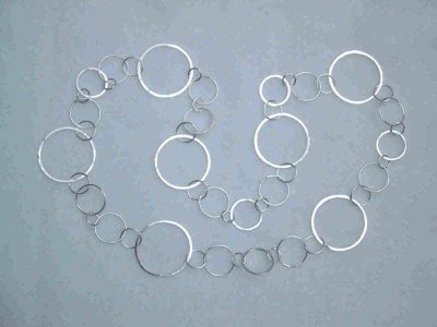 This necklace of sterling silver circles is 92cm in length, and weighs 50 grams.  It can be worn as a long loop or doubled up to be worn as a short necklace (a separate hook is included). Sold