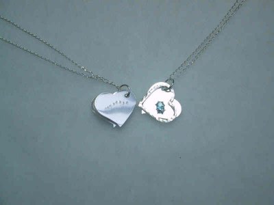 These pendants are about 2 cm x 2cm, with a birthstone on the facing side and a name on the reverse. The floating heart adds charm and movement.