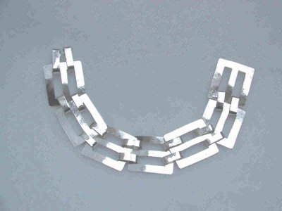 6 square links make up this bracelet.  Each is hand-cut and filed to fit. A safety chain was added for security while wearing. SOLD