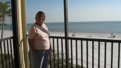 Betty in front of her beach view
