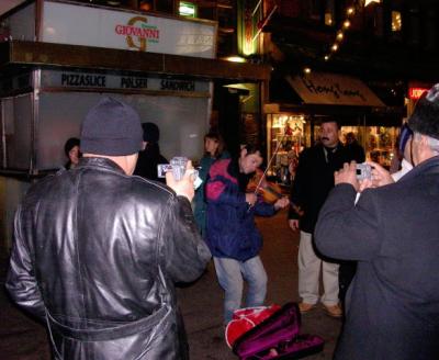 Street musician being photographed