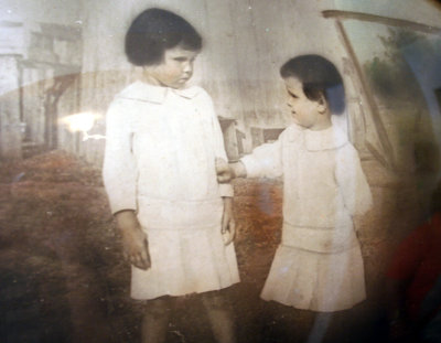 My grandmother (ri) and her sister Lois in front of thier smokehouse