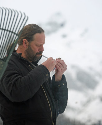 Dave Lighting Up After Work Is Done In Trinity,, Buck Mountain In Background