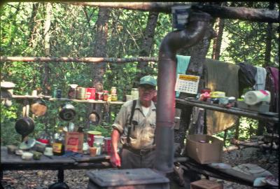 Rex Williams at his cabin and outdoor kitchen 1977
