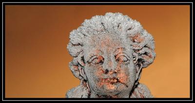 Bronze madonna with crystal hair in the sunset
