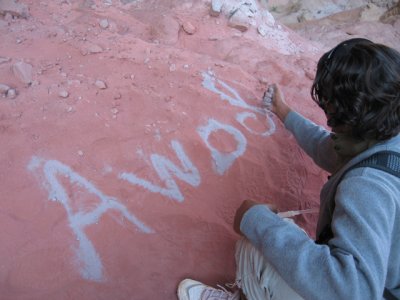 Our guide writes his name with sand so that we know what to yell if we get lost.