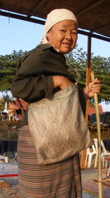 Tribal woman begging at riverbank cafe