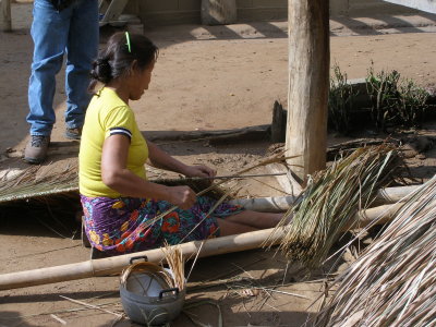 Village woman weaving thatch