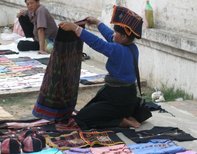 Hmong woman selling embroidered and handwoven clothes