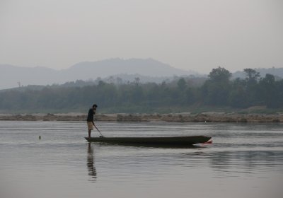 Mekong fisherman - using mobile phone