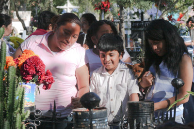 This family comes to the gravesite with their little dog.