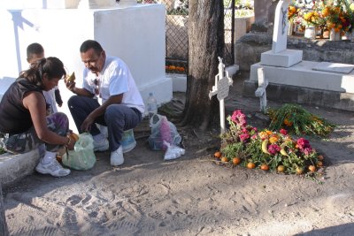 This family eats next to the grave.