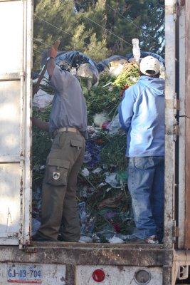 This huge truck is loaded with dead flowers from the cemetery.
