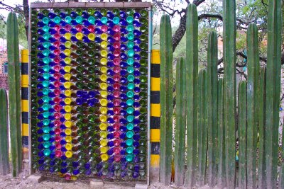 What do you do with an old bed spring, a bunch of wine bottles and tall, skinny cacti?  Build a fence, of course!
