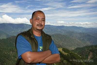 This was taken at the viewing deck of the highest point marker at Atok, Benguet. I set the exposure values of the 350D + Sigma 10-20 
by metering off the brightest part of the sky, popped up the on-board flash, dialled in some FEC, then asked my brother Jeff to snap a pic....:)