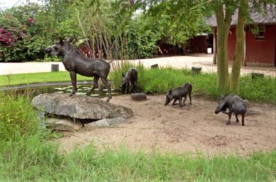 One Is Greeted By Bronze Warthogs