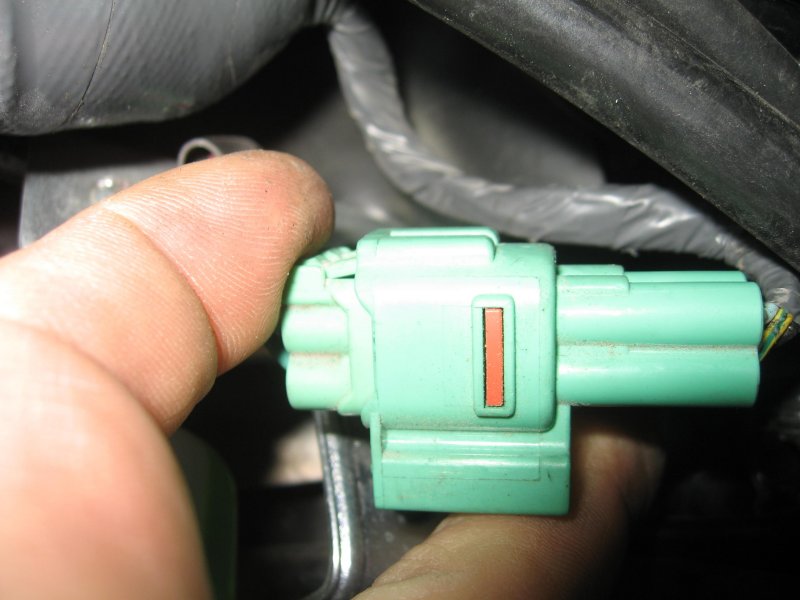Release the connector by squeezing the tab on it and pulling the two halves apart