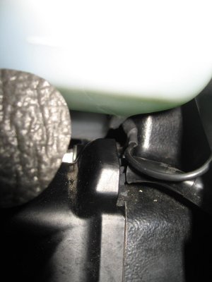 With coolant reservoir in position, note ground wire position