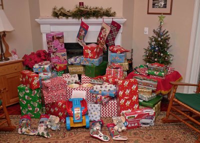 A BIG PILE OF CHRISTMAS GIFTS AWAIT THE FAMILY