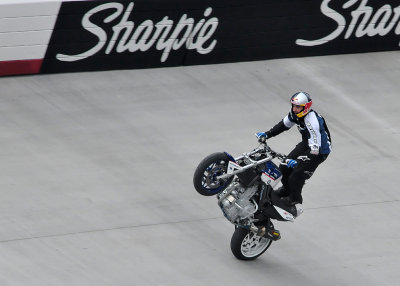 MOTORCYCLE STUNT RIDER,  CHRISTIAN PFEIFFER, ENTERTAINS THE CROWD BEFORE THE RACE