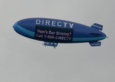 THE BLIMP PROVIDES OVERHEAD CAMERA SHOTS OF THE RACE AND ADVERTISING