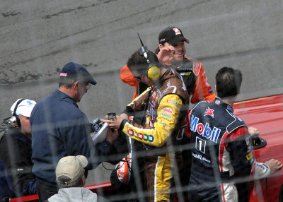 TONY STEWART WAVES TO THE CROWD DURING THE PRE-RACE DRIVER'S PARADE