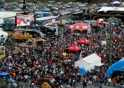 A LARGE CROWD WATCHES THE SPEED CHANNEL PRE-RACE BROADCAST (NOTE THE TV SCREEN AT TOP LEFT)