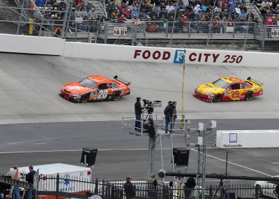 TONY STEWARD  (#20) AND KEVIN HARVICK (#29) PASS BY A FOX SPORTS TV CREW, AS THEY HEAD FOR TURN FOUR
