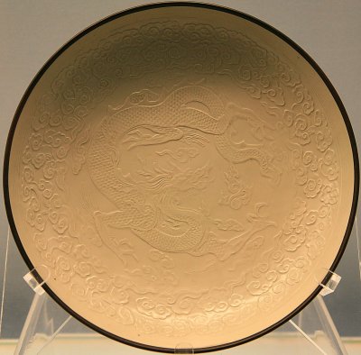 White glazed dish with moulded cloud and dragon design Ding Ware