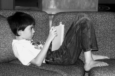 Barefoot boy with book
