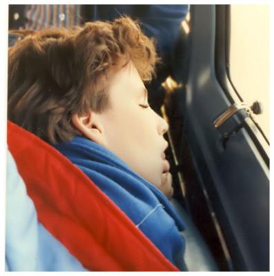 Boy naps in the van