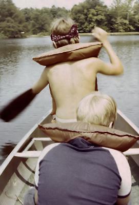 Boys paddle a canoe