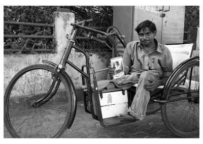 Sunil Khumar holding up a photo that I had taken of him, Mumbai