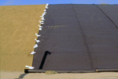 (ENV13) Sand on the surface of the landfill being covered with HDPE liner to prevent intusion of water, Lake County, IL
