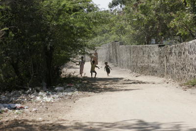 Children play along dirty streets