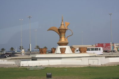 Dubai - All Points East - 1 of  many decorated roundabouts. This 1 signifies the unity of the 7 Emirates with 7 coffee cups