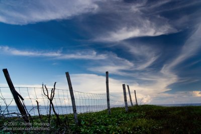 Magnificent clouds over fenced horizon