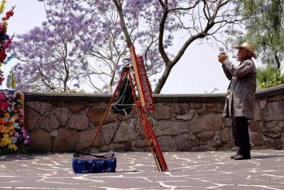 Picture of a guy taking pictures of pictures